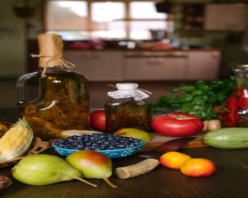 healthy fresh ingredients and water on a kitchen table